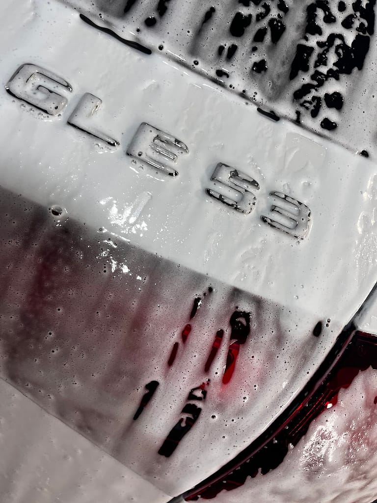 Foam washing a white Mercedes-AMG GLE53 before ceramic coating