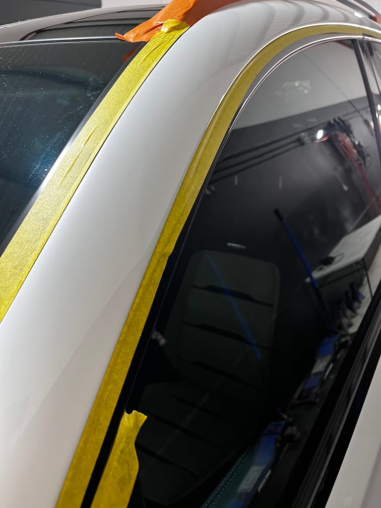 Mercedes-AMG GLE53 window trim carefully masked before machine polishing