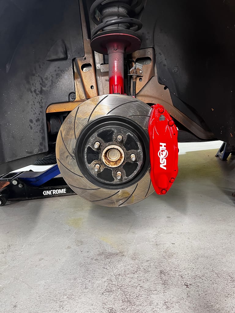 Finished red front caliper with white HSV logo behind the brake rotor