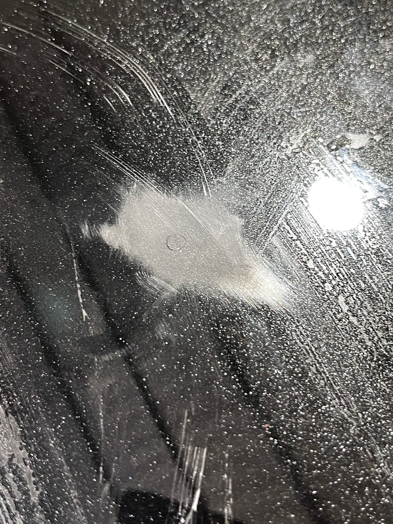 Controlled 2000-grit sanding around a touched-up chip on John's Outlander bonnet