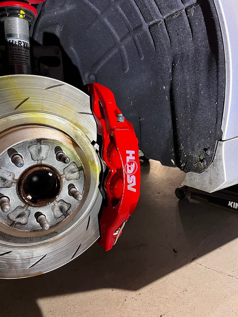 Close view of the original red VF Clubsport caliper retained with protective clear coat
