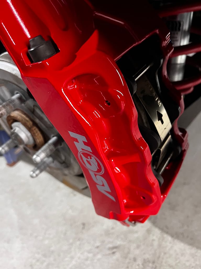 Original red VF Clubsport brake caliper and HSV logo after preservation