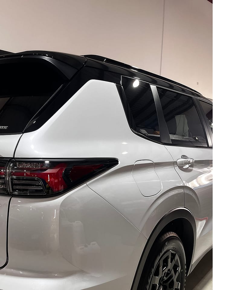 Rear quarter of a pearl-white Mitsubishi Outlander after FMJ coating